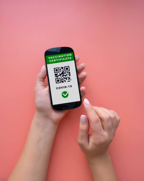 istock Women's hands hold a phone with an electronic Covid-19 vaccination certificate. 1355073593