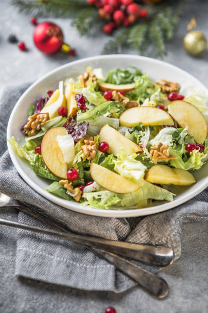 istock Fresh Waldorf salad with lettuce, green apples, walnuts and celery on wooden table. Top view.Copy space 1355074956