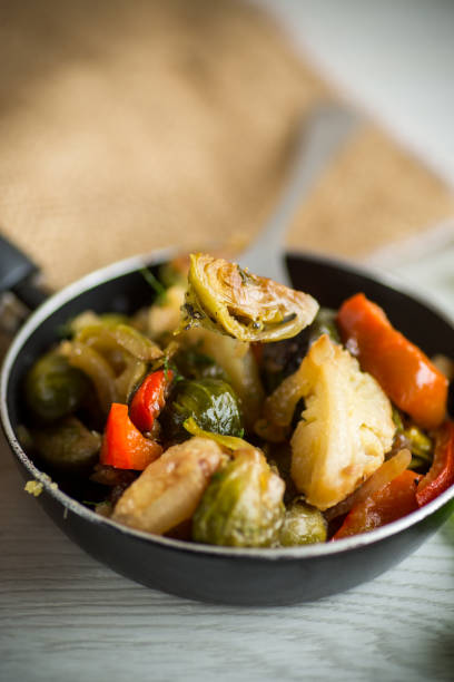 istock fried brussels sprouts with cauliflower and other vegetables in a frying pan 1355074964
