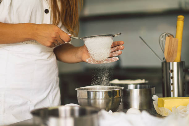 istock Hands working with dough preparation recipe bread, pizza or pie making ingridients. 1355076174