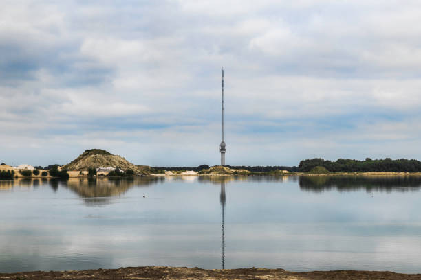 tv tower antennas in hoogersmilde in holland Tv-tower in Dutch landscape with reflection in the water, central perspective. hoogersmilde Drenthe Netherlands. hoogersmilde stock pictures, royalty-free photos & images