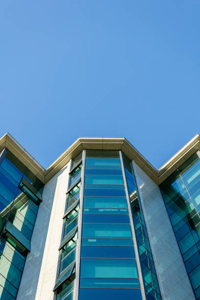 istock Low angle view on corporate building glass facade and skyline 1355080218