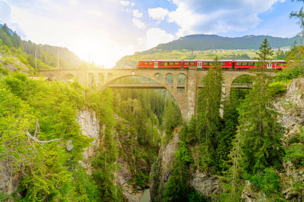istock Solis Viaduct of Swiss railway with red train 1355082830