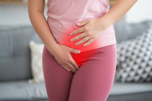 Menstrual pain, woman with stomachache suffering from pms at home, endometriosis, cystitis and other diseases of the urinary system stock photo