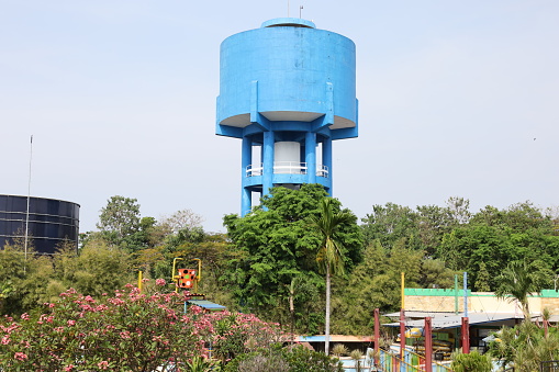 blue water tower on a high with blue sky background