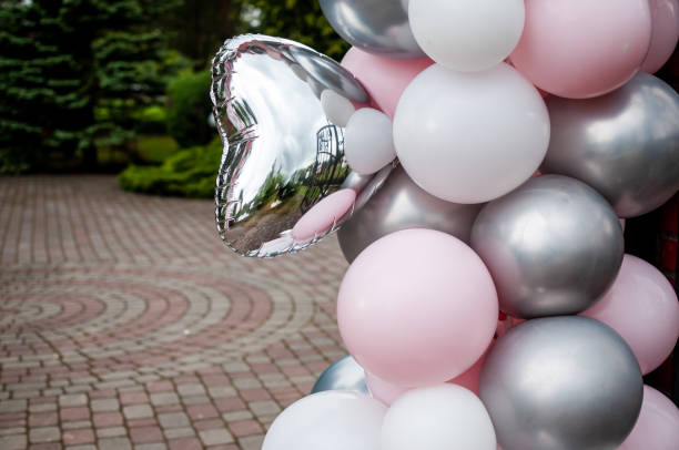 istock Pink grey and white inflatable balloons in the courtyard 1355083233