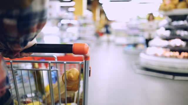 Cropped view of a man walking in the supermarket