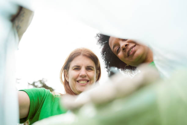 istock Volunteers collecting plastic in bag 1355087655
