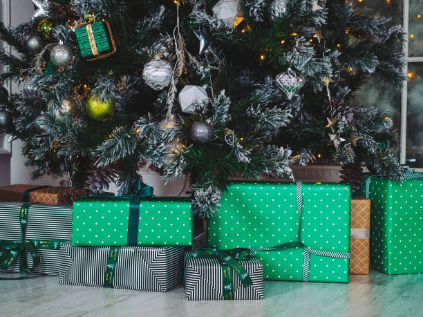 istock green gift boxes under a Christmas tree decorated with colorful toys 1355088904
