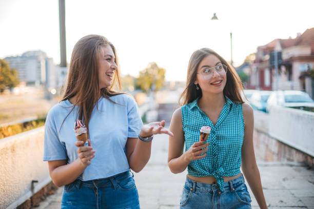istock Two young women are enjoying ice cream 1355090408