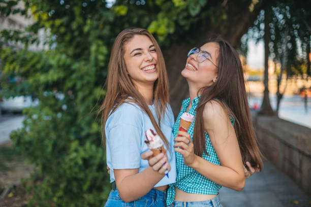 istock Two young women are enjoying ice cream 1355090420