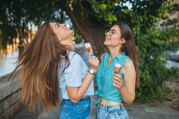 istock Two young women are enjoying ice cream 1355090428