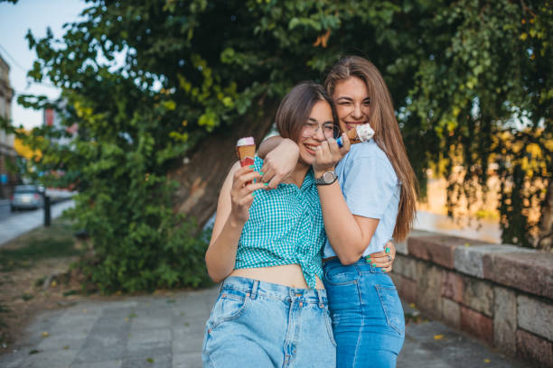 istock Two young women are enjoying ice cream 1355090445