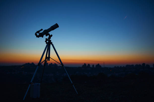 istock Astronomical telescope under a twilight sky ready for stargazing. 1355090883