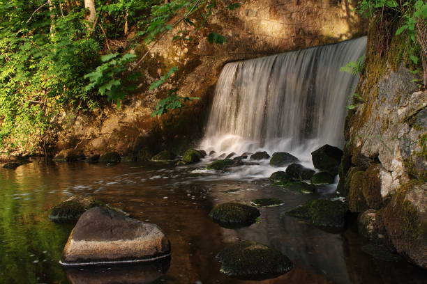 istock Waterfall in sunny summer day, Embute, Latvia 1355091106