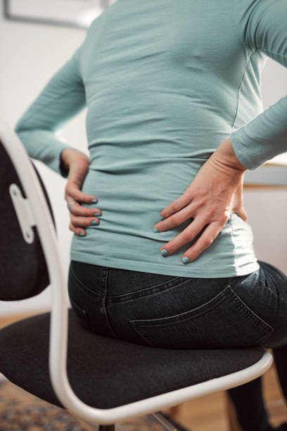 istock Woman with hip, back, spine spasm, cramp and pain, working from home troubles and issues. 1355092364