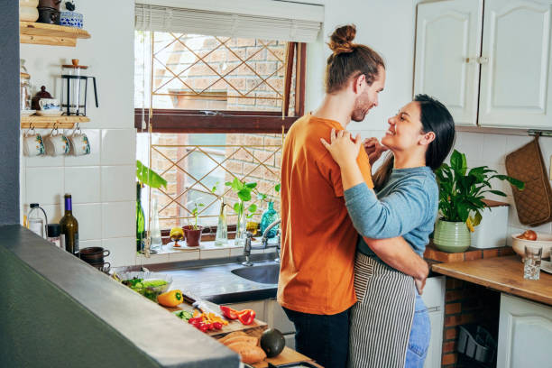 istock Shot of a young couple dancing in their kitchen 1355092590