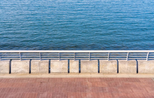 istock embankment from railing on blue sea background on the water surface. 1355093000