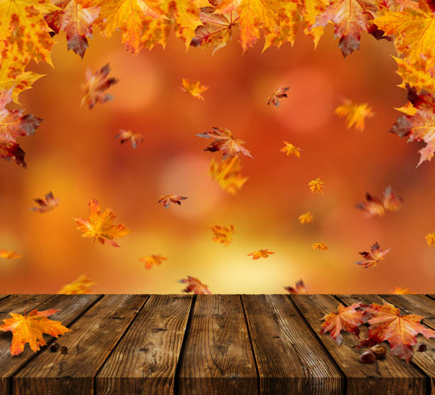 istock Maple Leaves with wooden Table and beautiful Autumn Background 1355099149