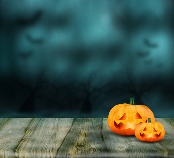 istock Pumpkins burning in a spooky Forest at Night - Halloween background 1355099201