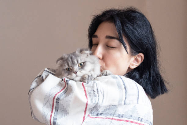 istock Woman kissing her cat 1355099504
