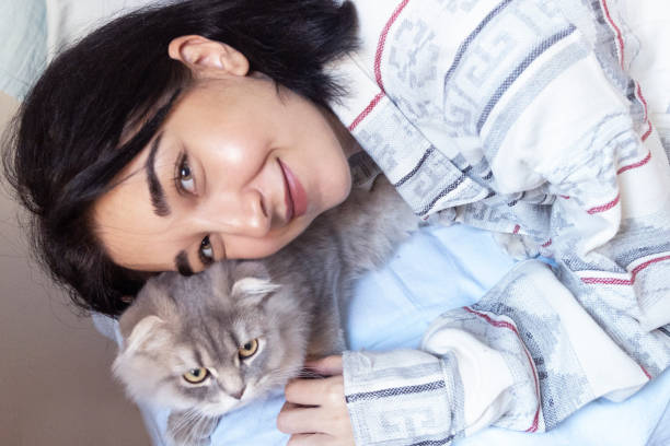 istock Cute cat and woman 1355099638