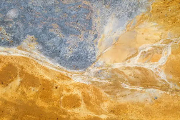 Colourful surface of abandoned pyrite mine tailings. Mining background, aerial view directly above