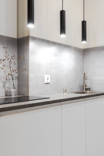 istock Minimalistic compact kitchen in a small apartment with elements of concrete, black and white 1355100895