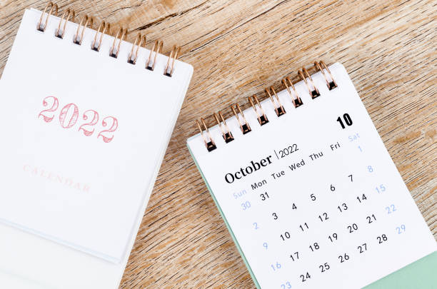 istock October 2022 desk calendar on wooden table. 1355101080