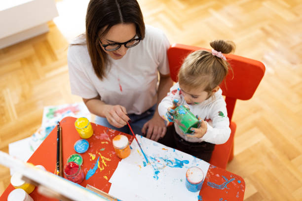 istock Mother paints together with the daughter 1355103586