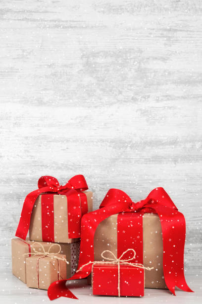 istock Christmas Gift Boxes on White Wooden Background 1355103779