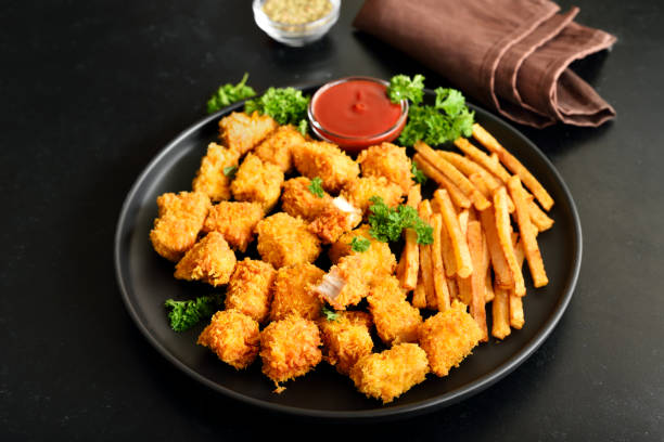 istock Crispy fried chicken nuggets, potato fries and tomato sauce 1355103822
