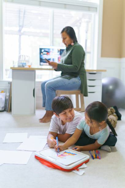 istock Busy woman with kids working from home 1355105832