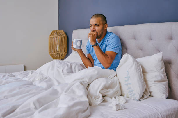 istock Shot of a young man suffering from a cold at home 1355106278