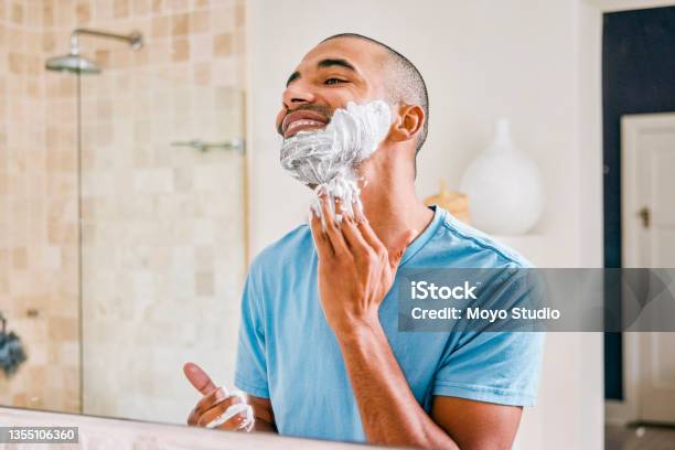 Shot Of A Young Man Applying Shaving Cream To His Face In A Bathroom At Home Stock Photo - Download Image Now