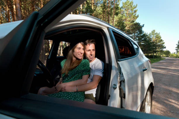 istock Side view of unrecognizable couple sightseeing in a car. 1355108617