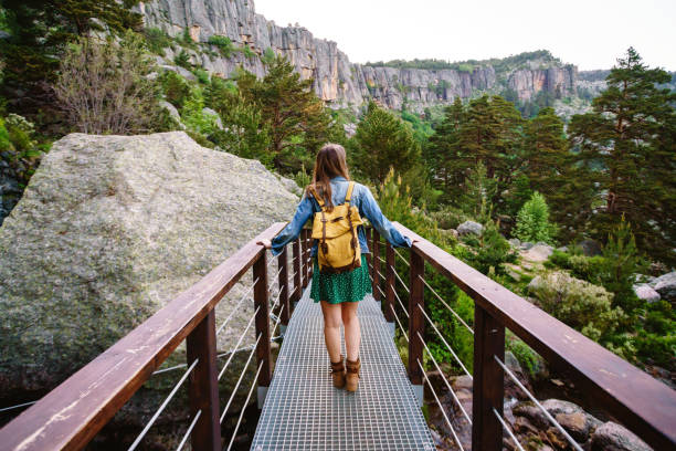 Panoramic view of unrecognizable woman walking isolated in nature with backpack.