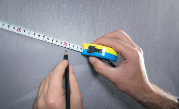istock Measuring tape and pencil marking with a wall. 1355110097
