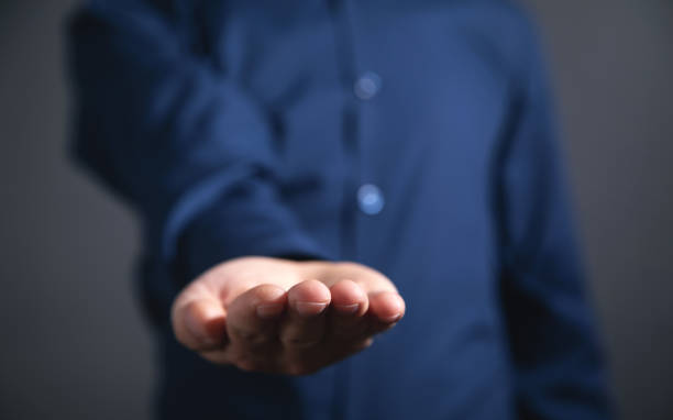 istock Caucasian businessman showing empty hand. 1355110099