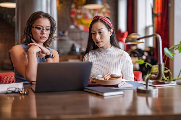 istock Two businesswoman working in office 1355110795