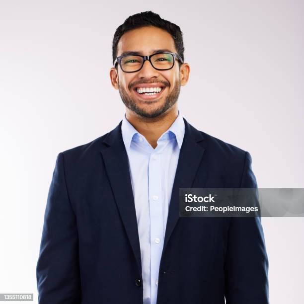 Studio Shot Of A Handsome And Happy Young Man Posing Against A Grey Background Stock Photo - Download Image Now