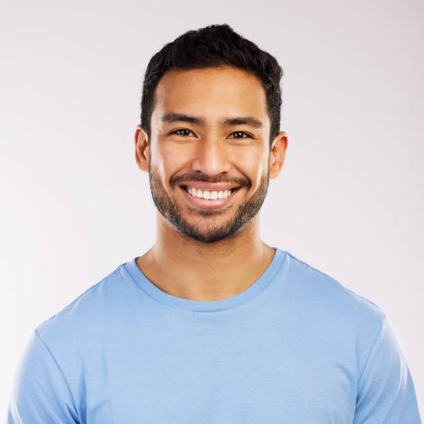 istock Studio shot of a handsome and happy young man posing against a grey background 1355110844