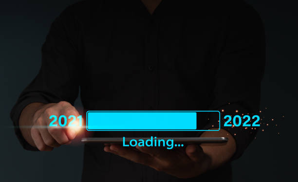 istock A businessman touches a virtual download bar with a loading progress bar on New Year's Eve, turning the year 2021 to 2022. 1355111446