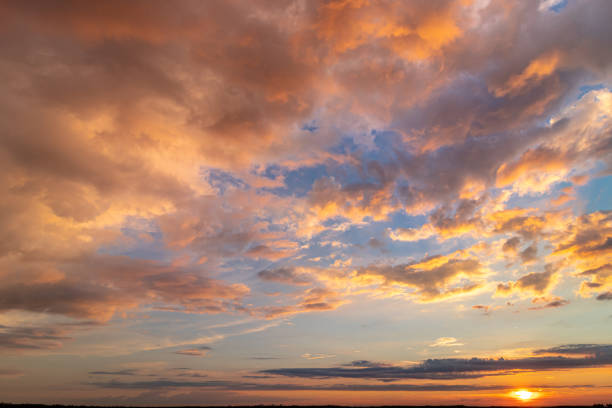 istock Colorful sunset with clouds in the evening. 1355113055