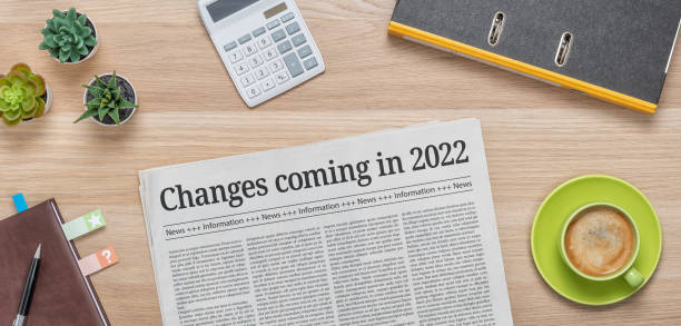 A newspaper on a desk with the headline Changes coming in 2022 A newspaper on a desk with the headline Changes coming in 2022 front page stock pictures, royalty-free photos & images