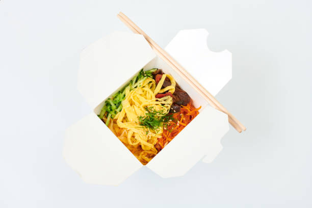 istock Rice wok in box and bamboo chopsticks isolated on white background, takeout and takeaway concept 1355119556