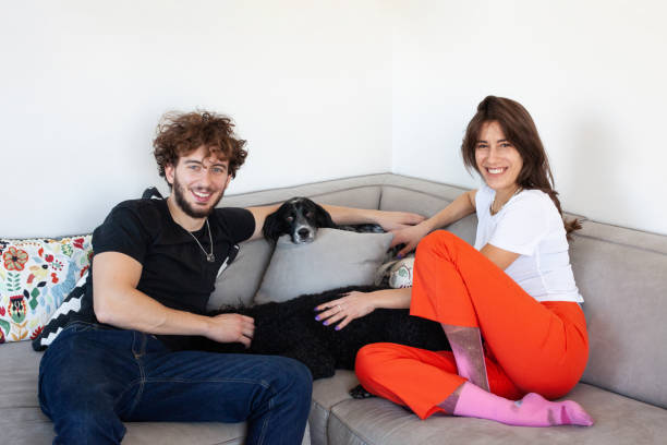 istock Young couple with their dogs at home 1355121108