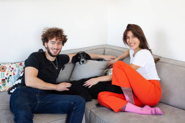 istock Young couple with their dogs at home 1355121136