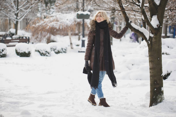 istock Beautiful woman posing in winter Park. 1355121353