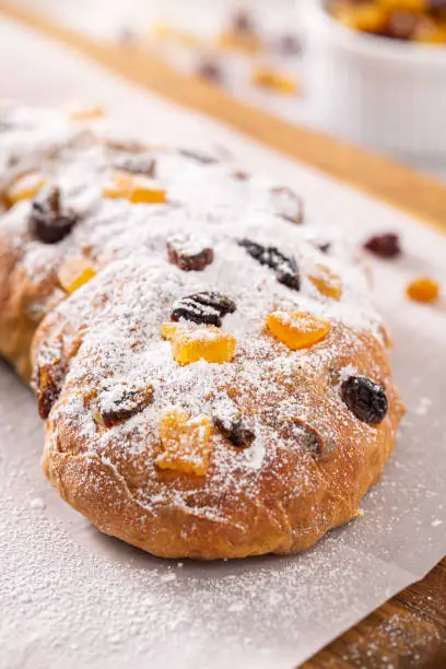 Traditional German stollen Christmas / holiday bread with candied fruit and and powdered sugar